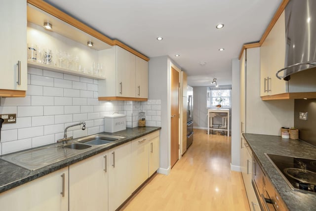 The property includes this contemporary kitchen with attractive units.
