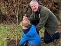 Lord-Lieutenant Richard Callander and his grandson busy planting a tree.