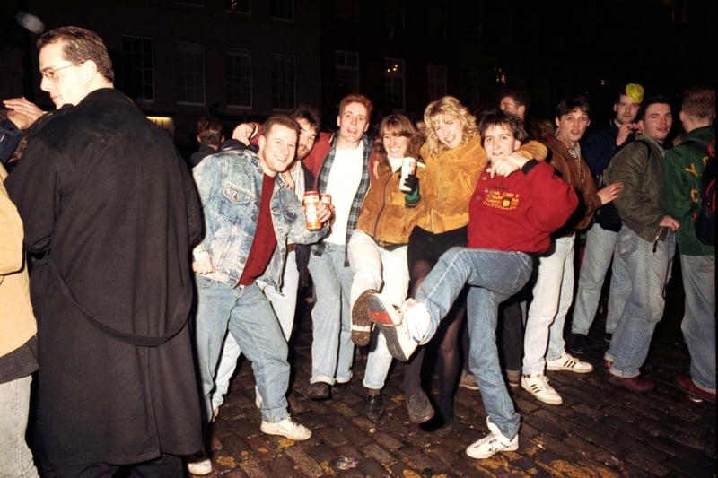Before the organised and multi-million pound Edinburgh Hogmanay celebrations were introduced in the late 90s, Edinburgers brought in the bells at the Tron, off the High Street at Hunter Square. Teenagers pictured having a knees-up at the Tron Kirk in Edinburgh on Hogmanay 1990.