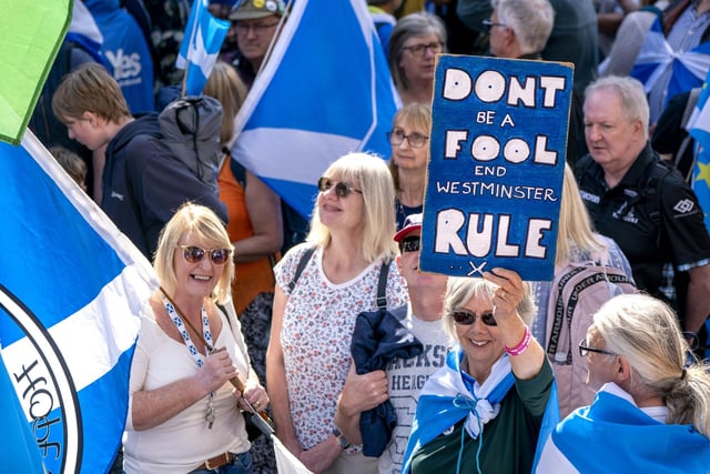 Many of those who took part in a Believe in Scotland march and rally in Edinburgh held handmade signs and waved flags. Photo credit should read: Jane Barlow/PA Wire
