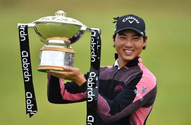 Min Woo Lee of Australia celebrates with the trophy after winning the abrdn Scottish Open at The Renaissance Club. Picture: Mark Runnacles/Getty Images.