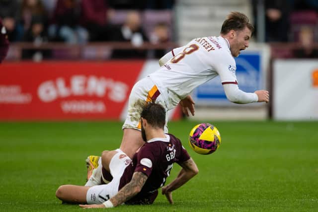 Motherwell's Callum Slattery is tackled by Hearts midfielder Jorge Grant.
