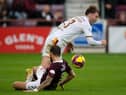 Motherwell's Callum Slattery is tackled by Hearts midfielder Jorge Grant.