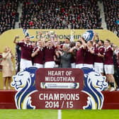 The Hearts players celebrate as they lift the Scottish Championship trophy after a 2-2 draw with Rangers at Tynecastle on May 2, 2015.