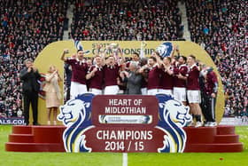 The Hearts players celebrate as they lift the Scottish Championship trophy after a 2-2 draw with Rangers at Tynecastle on May 2, 2015.