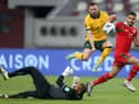 Martin Boyle of Australia and Faiz al-Rushaidi goalkeeper of Oman and Ali al-Busaidi battle for the ball during the 2022 FIFA World Cup Qualifier match between Australia and Oman at Khalifa International Stadium on October 7, 2021 in Doha, Qatar. (Photo by Mohamed Farag/Getty Images)