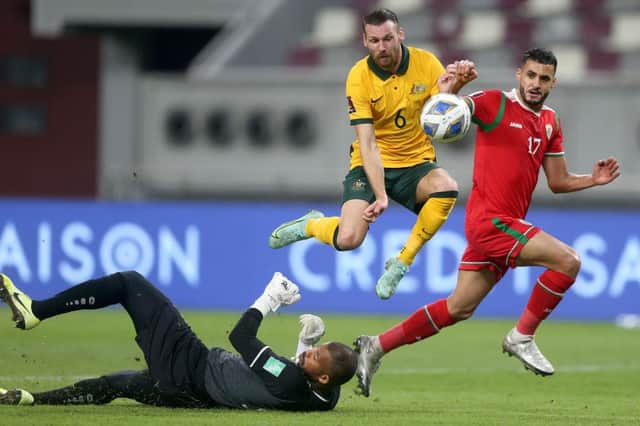 Martin Boyle of Australia and Faiz al-Rushaidi goalkeeper of Oman and Ali al-Busaidi battle for the ball during the 2022 FIFA World Cup Qualifier match between Australia and Oman at Khalifa International Stadium on October 7, 2021 in Doha, Qatar. (Photo by Mohamed Farag/Getty Images)