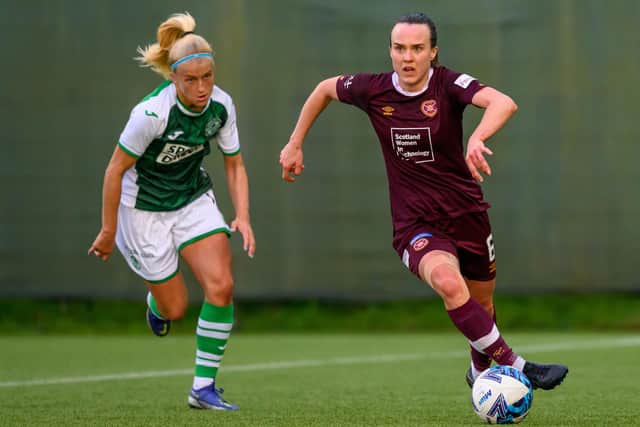 Hearts midfielder Ciara Grant moves in possession of the ball with Hibs attacker Katie Lockwood in pursuit. Picture: Malcolm Mackenzie