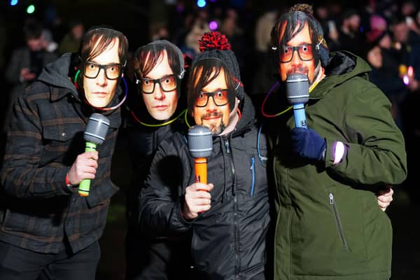 Revellers wear Jarvis Cocker masks ahead of Pulp playing at the New Year Hogmanay Street Party and Concert celebrations in Edinburgh.