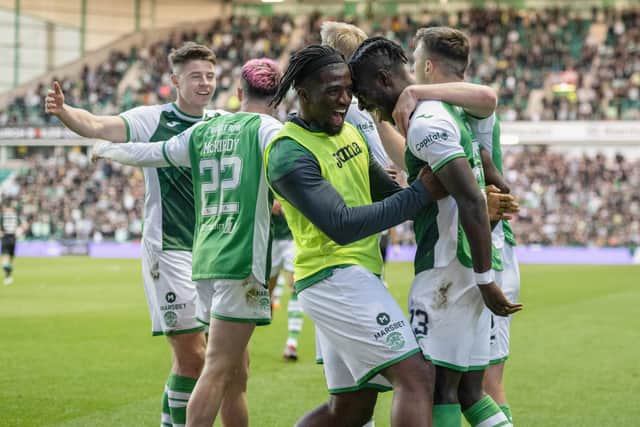 Élie Youan, second right, is mobbed after scoring his second, and Hibs' third against Celtic