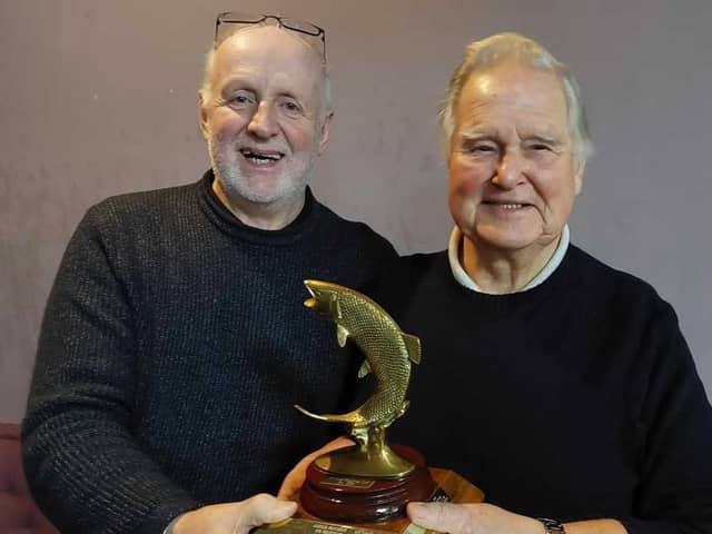 Secretary Alex Rose (left), of Malleny Angling, presents Ronnie Robinson with the Chairman's Trophy for his outstanding contribution to the club.