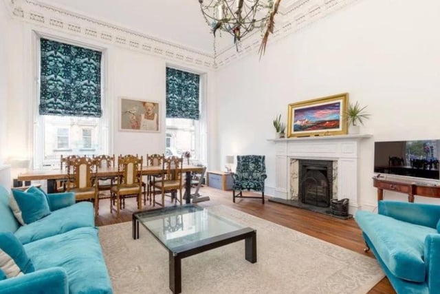 The upper floor of the stylish apartment boasts a large drawing room, complete with charming features including a carved wooden fireplace