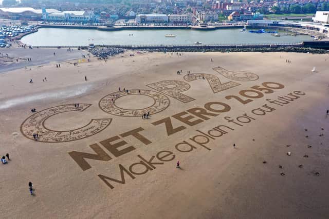 The world's attention is turning towards the Cop26 climate summit in Glasgow as this sand art on a beach in the Wirral, Merseyside shows (Picture: Christopher Furlong/Getty Images)