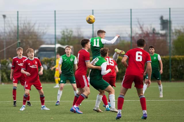 Josh McCulloch (No.11) beats Findlay Marshall (No.15) and Finlay Murray (No.4)  to an aerial ball during the Under-18s clash at HTC. Picture: Maurice Dougan
