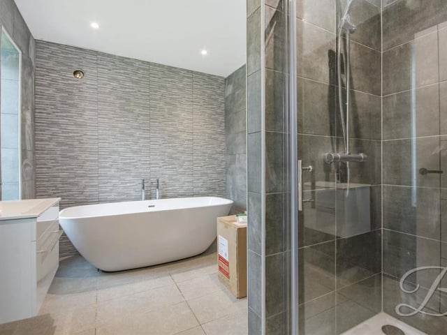 Another example of the quality that radiates through the property. En suite facilities that again include a free-standing bath and walk-in shower.