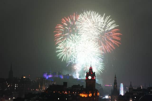 Fireworks explode over Edinburgh Castle during the Hogmanay street party. Pictured: Andrew Milligan/PA Wire