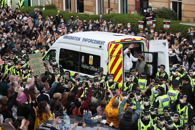 Lakhvir Singh and Sumit Sehdev are released from the back of a Home Office immigration enforcement van in a Glasgow street after crowds of people prevented it from leaving (Picture: Andrew Milligan/PA)