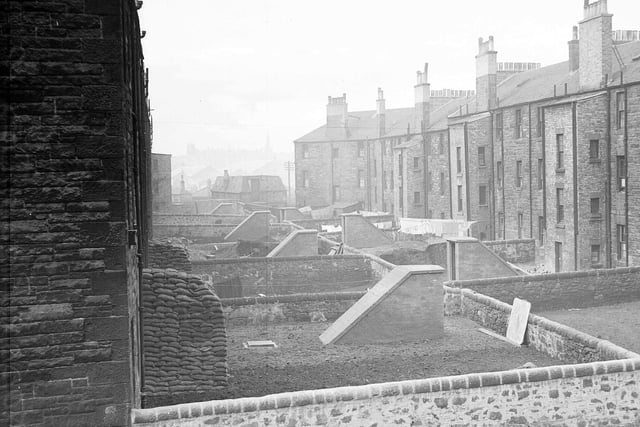 Air raid shelters in Easter Road, Edinburgh tenement back greens, with sandbags, March 1943.