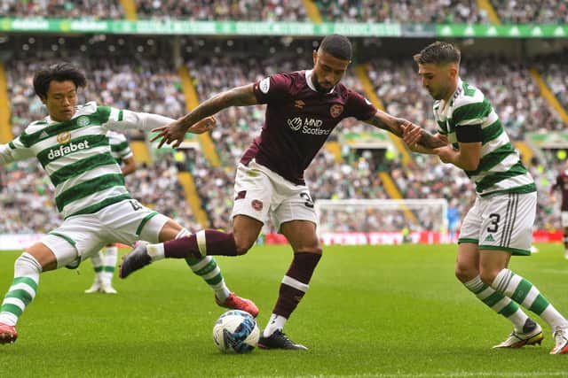 GLASGOW, SCOTLAND - AUGUST 21: Hearts' Josh Ginnelly and Celtic's Reo Hatete (L) and Greg Taylor (R) in action during a cinch Premiership match between Celtic and Hearts at Celtic Park, on August 21, 2022, in Glasgow, Scotland. (Photo by Craig Foy / SNS Group)