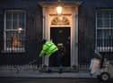 A man cleans the street in front of  10 Downing Street, London. The UK and European Union are on the threshold of striking a post-Brexit trade deal. An announcement is expected on Christmas Eve, but talks have continued through the night on the details of an agreement picture: Victoria Jones/PA Wire