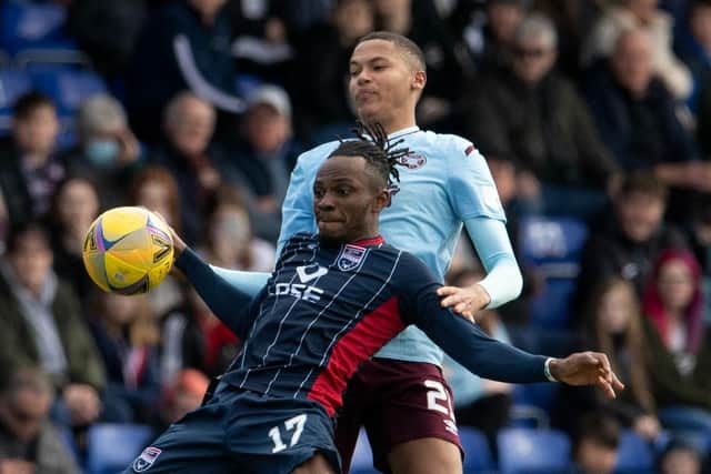 Toby Sibbick in action against Regan Charles-Cook in Saturday's match between Hearts and Ross County in Dingwall. Picture: SNS
