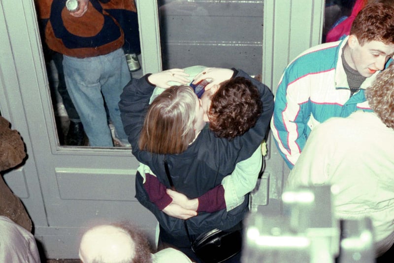 A young couple kissing as midnight chimes at the Tron Kirk in Edinburgh on Hogmanay 1990.