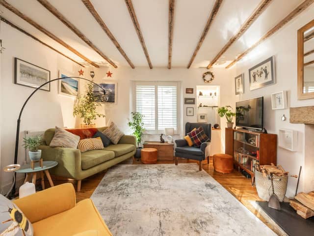 There is a charming, front-facing lounge with exposed beams, fireplace incorporating the log burner and working shutters.