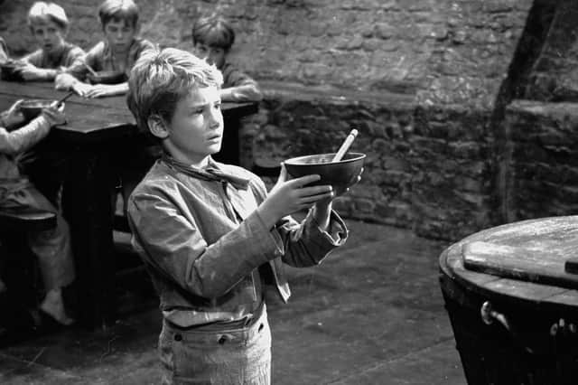 Oliver Twist asks for some more gruel during the filming of the 1968 musical 'Oliver' (Picture: Chris Ware/Keystone Features/Getty Images)