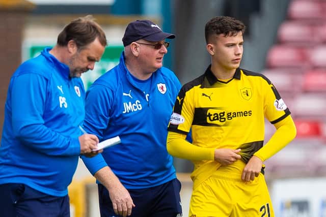 A young Tait is given instructions by McGlynn and Paul Smith before coming on as a sub for Raith in 2019