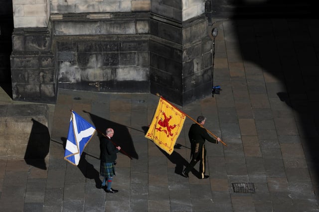 The Lion Rampant and Saltire flags are carried into St Giles' Cathedral, Edinburgh, following a Service of Prayer and Reflection for her life.