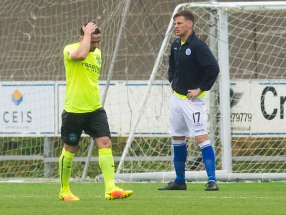 A disconsolate Lewis Stevenson walks off after picking up an early second half red card at Palmerston Park