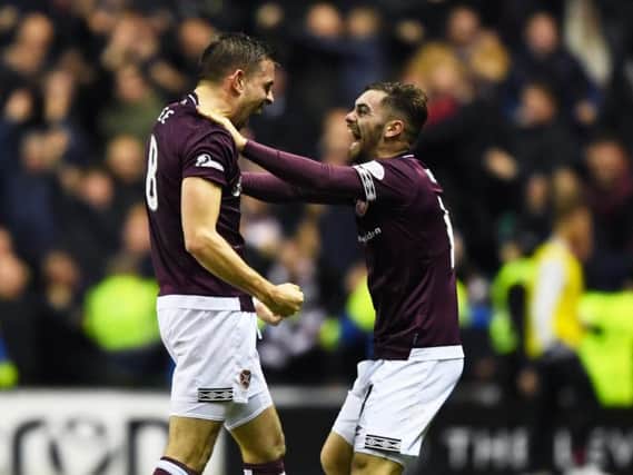 Hearts midfielder Olly Lee (left) celebrates his stunning opening goal at Easter Road with team-mate Ben Garruccio