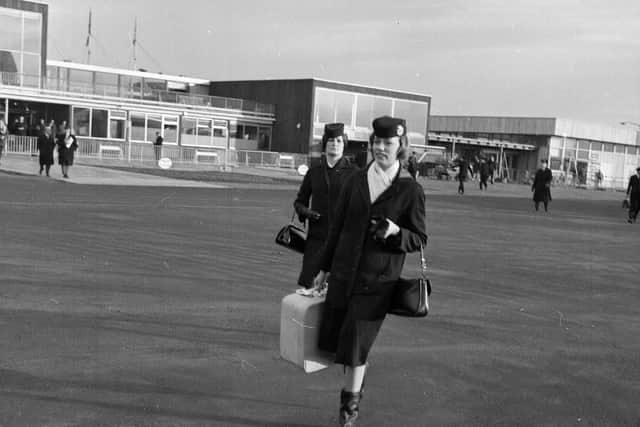 Two stewardesses arrive from London, 1964.