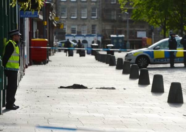 The Grassmarket, with an area containing blood stained clothes, cordoned off. Picture:  Neil Hanna