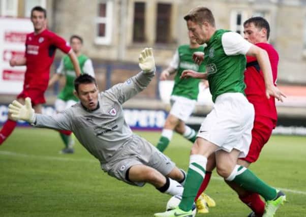 Hibernian's Paul Cairney is closed down by David McGurn. Picture: SNS