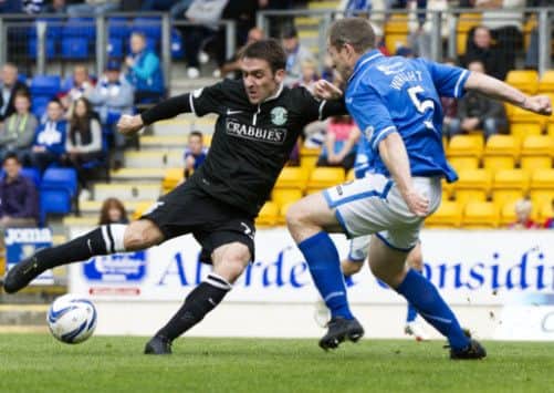 Paul Heffernan - who scored Hibernian's first - takes on Frazer Wright. Picture: SNS