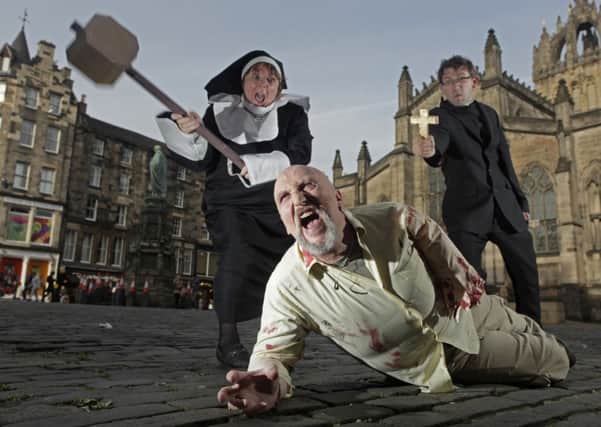 Zombie Billy Wilson is chased by nun Mags Henderson and priest Will Samson on the Royal Mile. Picture: Toby Williams