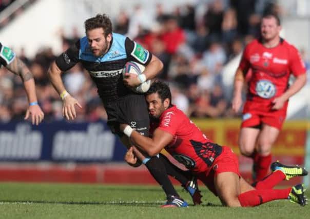 Ruaridh Jackson of Glasgow is tackled by Maxime Mermoz. Picture: Getty