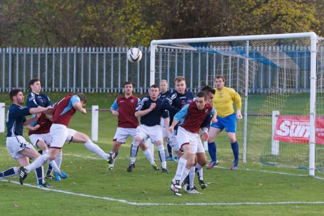 Welfares Andrew Kidd heads in an effort during a game where Aaron Somerville,below, scored a hat-trick of penalties. Picture: Joey Kelly.