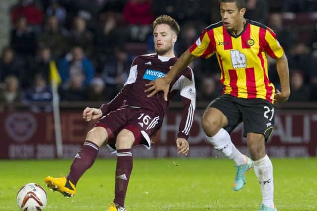 Hearts' Brad McKay finds himself under pressure from new Partick Thistle striker Lyle Taylor (right). Picture: SNS