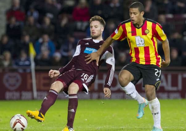 Hearts' Brad McKay finds himself under pressure from new Partick Thistle striker Lyle Taylor (right). Picture: SNS