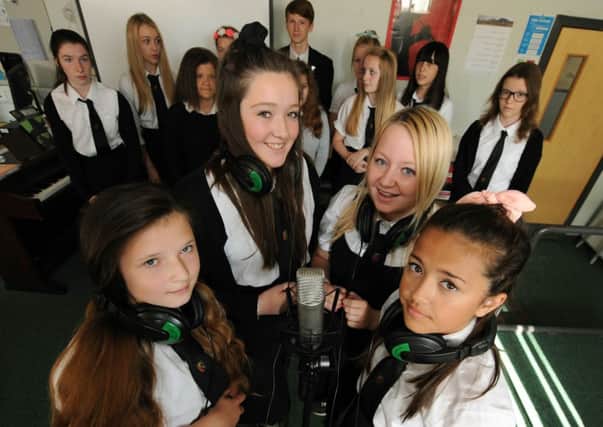 Front, from left, Megan OHara, Teri Mason, Ellie Graham and Mya Arnot join their classmates to record the song for Keane. Picture: Lisa Ferguson