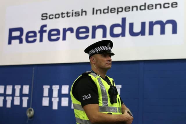 A police officer in the Highland Hall at the Royal Highland Centre during the count for the Scottish Referendum.
Pic: Andrew Milligan/PA Wire