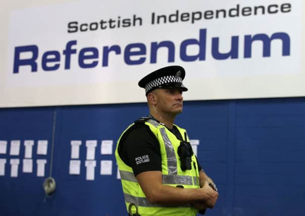 A police officer in the Highland Hall at the Royal Highland Centre during the count for the Scottish Referendum.

 Pic: Andrew Milligan/PA Wire
