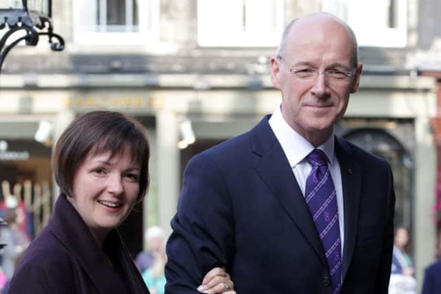 John Swinney arrives at St Giles Cathedral with his wife Elizabeth Quigley