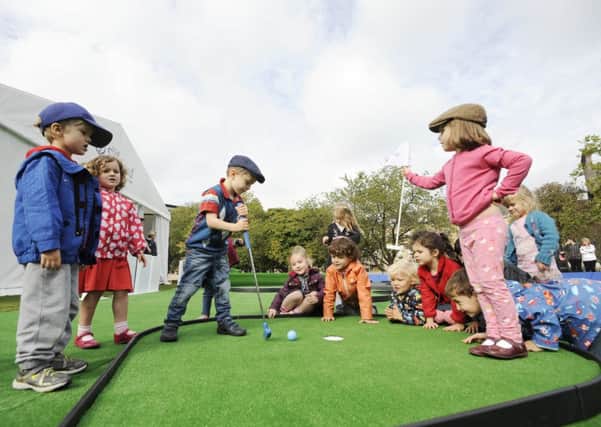 Children from Edinburgh Nursery try mini golf at the St Andrew Square fan zone. Picture: Greg Macvean
