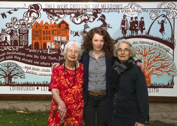 Heather Goodare, artist Astrid Jaekel and poet Rachel Woolf in front of the Meadows mural. Picture: Lesley Martin