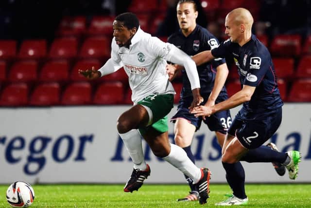 Hibernian's Dominique Malonga (left) is challenged by Tim Dreesen of Ross County in the League Cup third round tie.