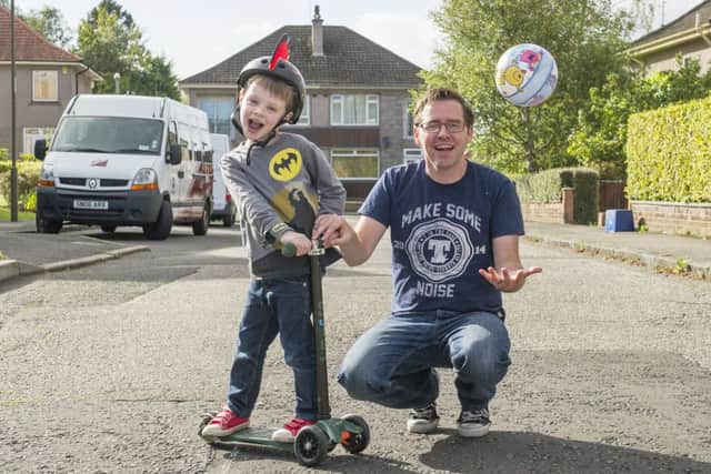 Thomas Lynch and son Lewis on Parkgrove Terrace, which could soon be a safe zone for children to play in at certain times of the day. Picture: Lesley Martin