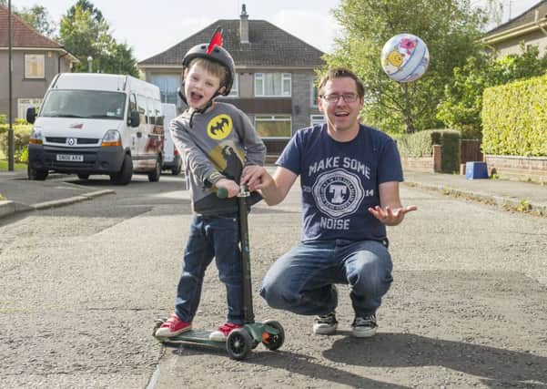 Thomas Lynch and son Lewis on Parkgrove Terrace, which could soon be a safe zone for children to play in at certain times of the day. Picture: Lesley Martin